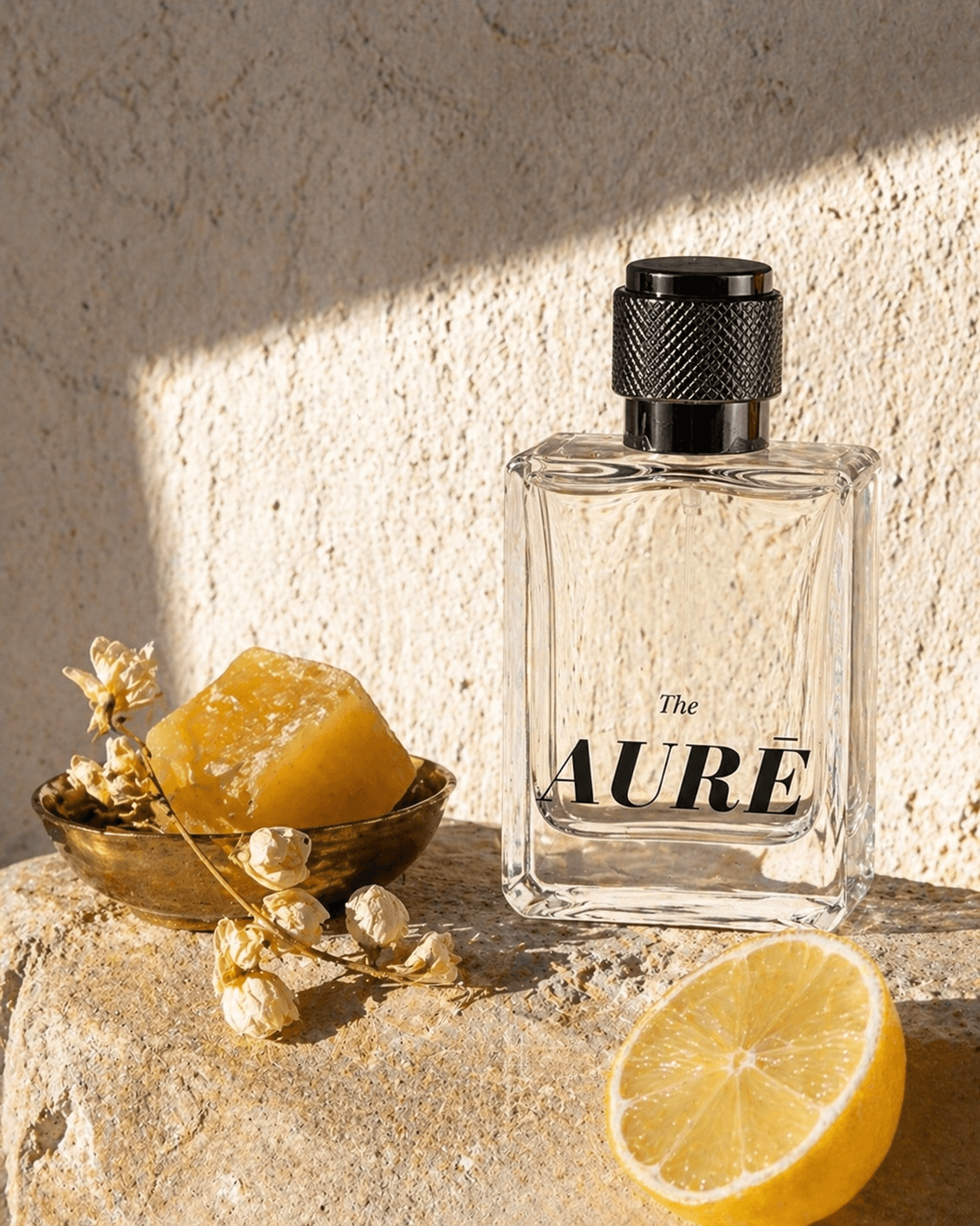 Solid wax perfume tin alongside AURĒ perfume bottle